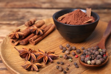 Aromatic anise stars and spices on wooden table