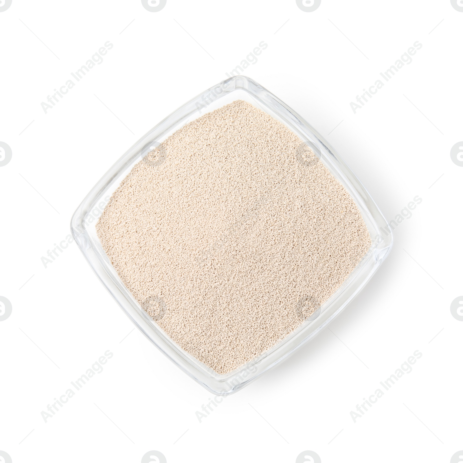 Photo of Granulated yeast in glass bowl isolated on white, top view