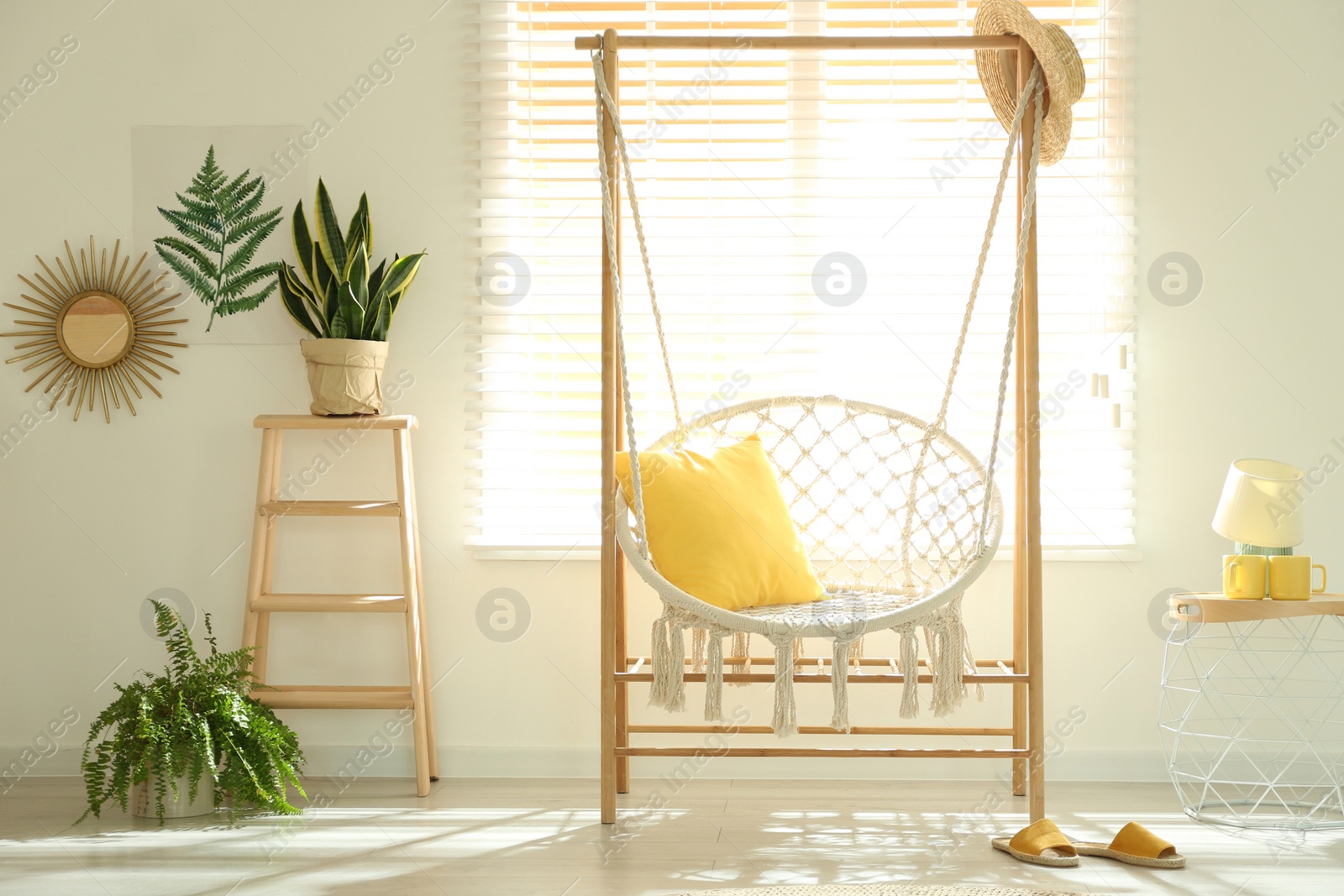 Photo of Comfortable hammock chair in stylish room. Home interior