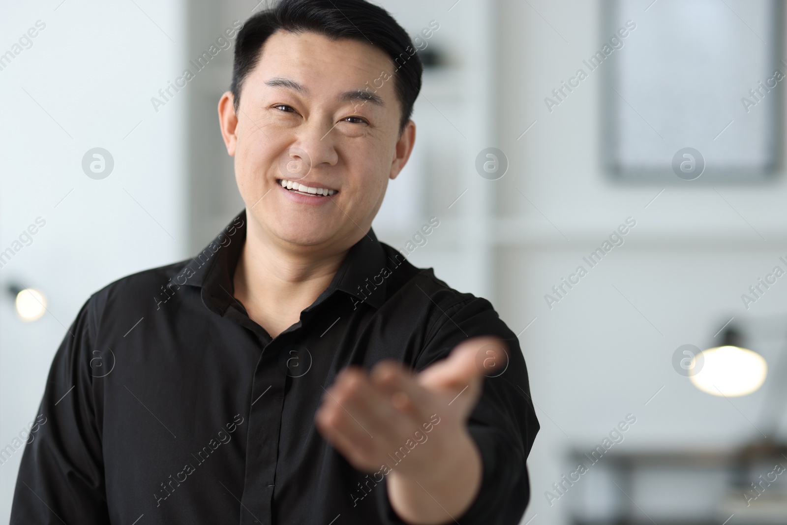 Photo of Portrait of smiling businessman in office. Space for text