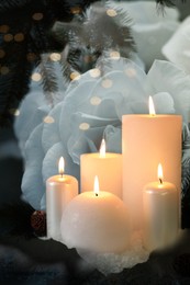 Funeral. Burning candles, white roses and fir branches, double exposure. Bokeh effect