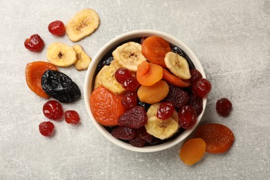 Photo of Mix of delicious dried fruits on grey table, flat lay