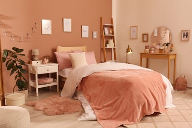 Photo of Teenage girl's bedroom interior with stylish furniture and beautiful decor elements