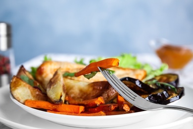 Delicious cooked vegetables and fork on plate, closeup. Healthy meals from air fryer