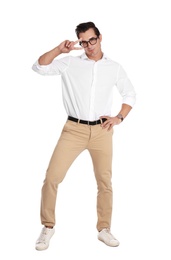 Handsome young man with glasses dancing on white background