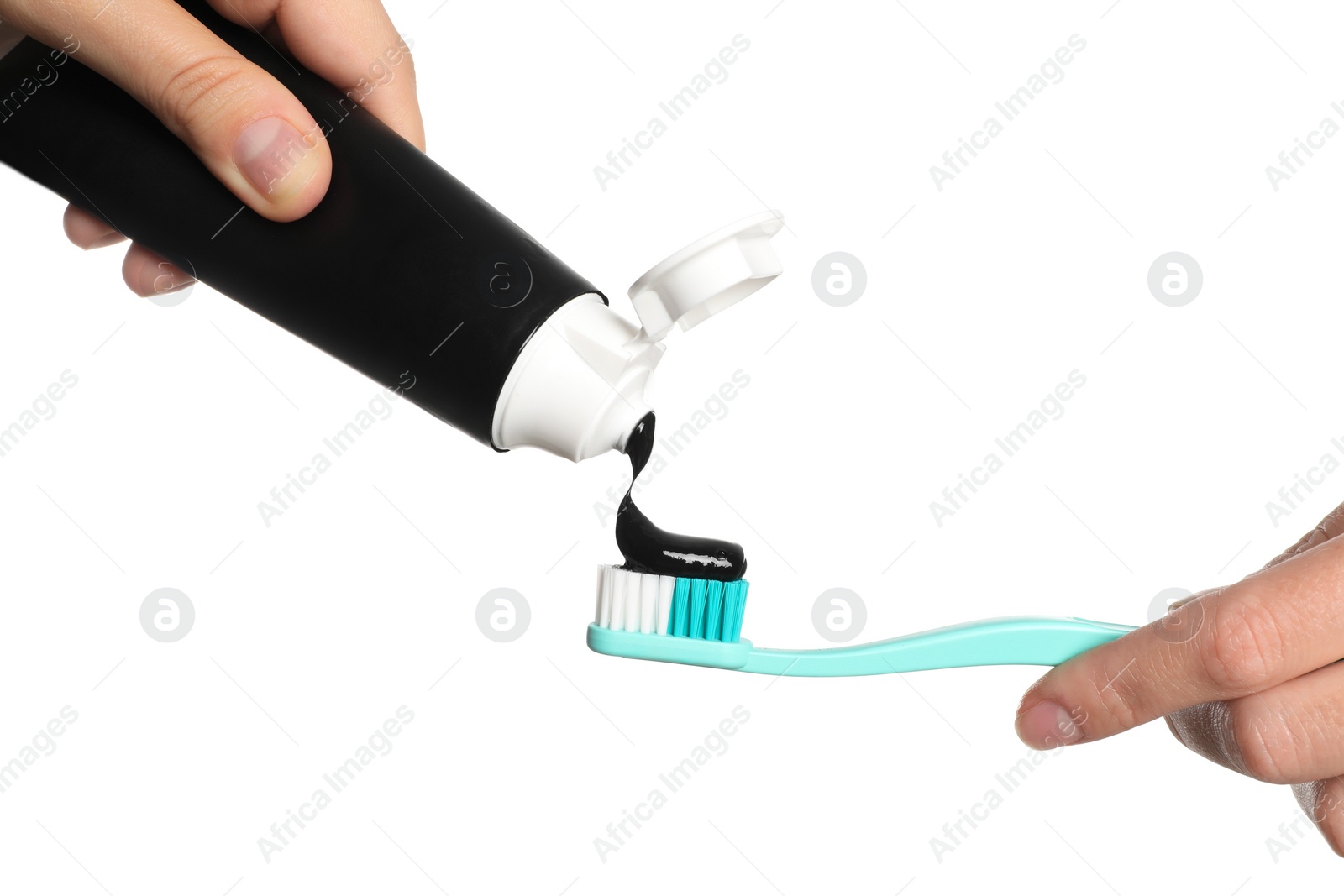 Photo of Woman applying charcoal toothpaste on brush against white background, closeup