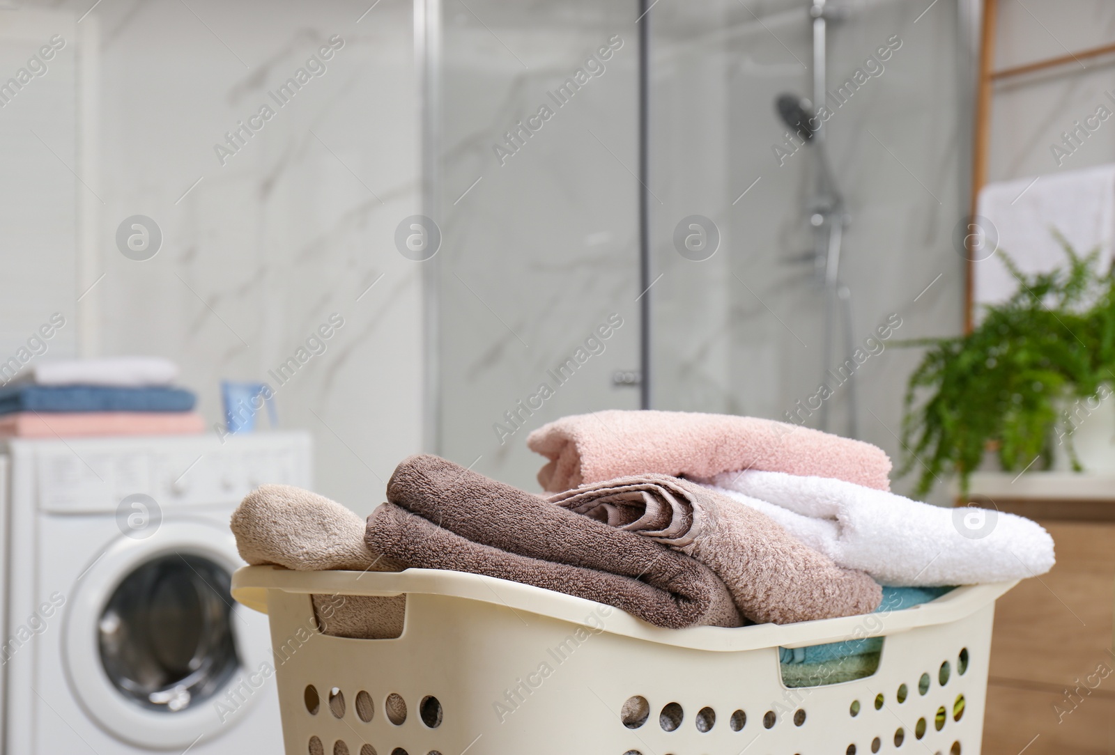 Photo of Laundry basket with towels in bathroom, closeup