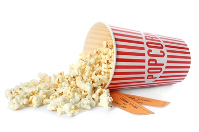 Photo of Bucket of fresh popcorn and tickets on white background. Cinema snack