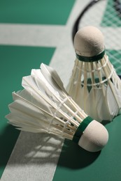 Photo of Two feather badminton shuttlecocks on court, closeup