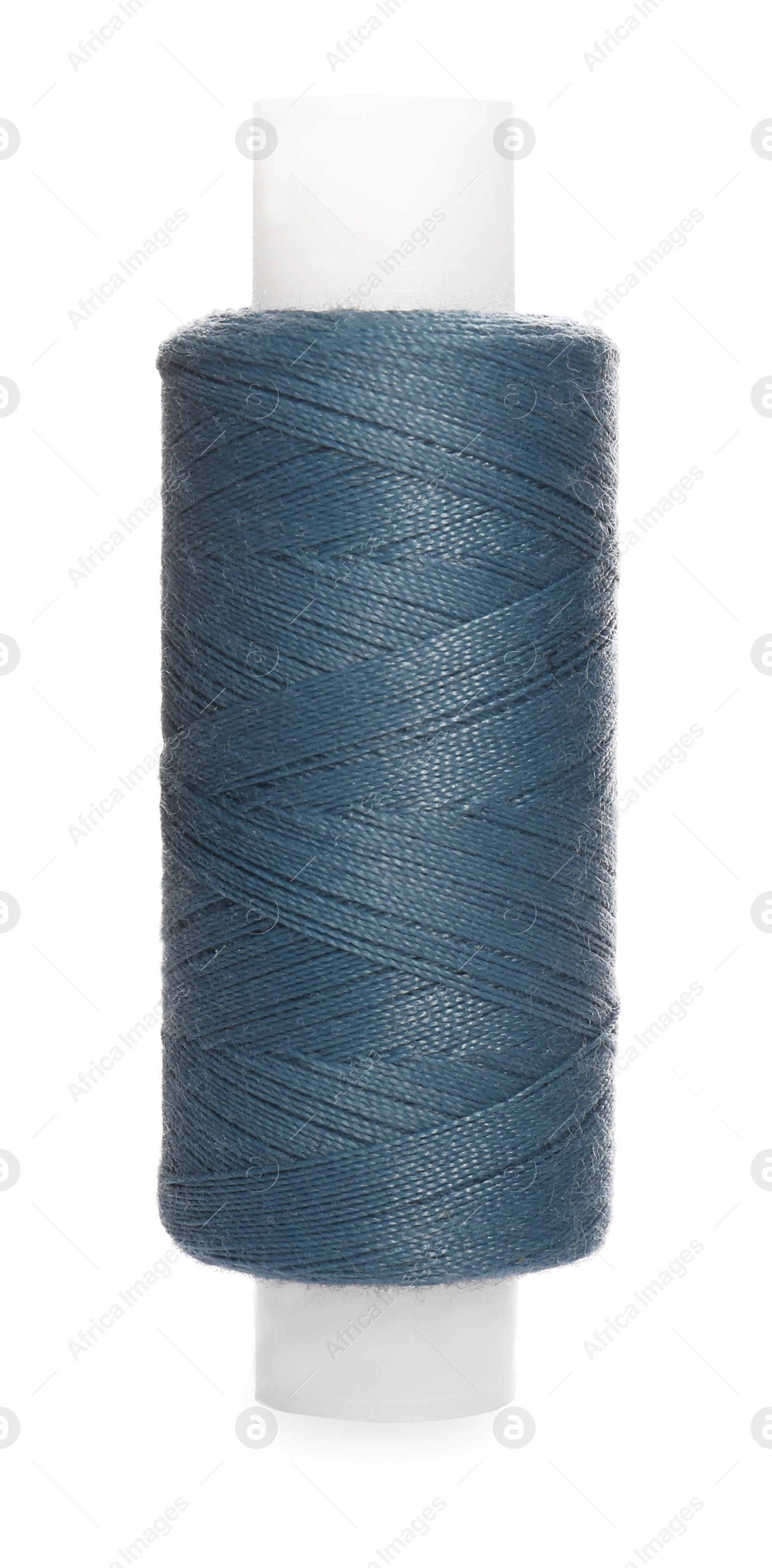 Photo of Spool of steel blue sewing thread isolated on white