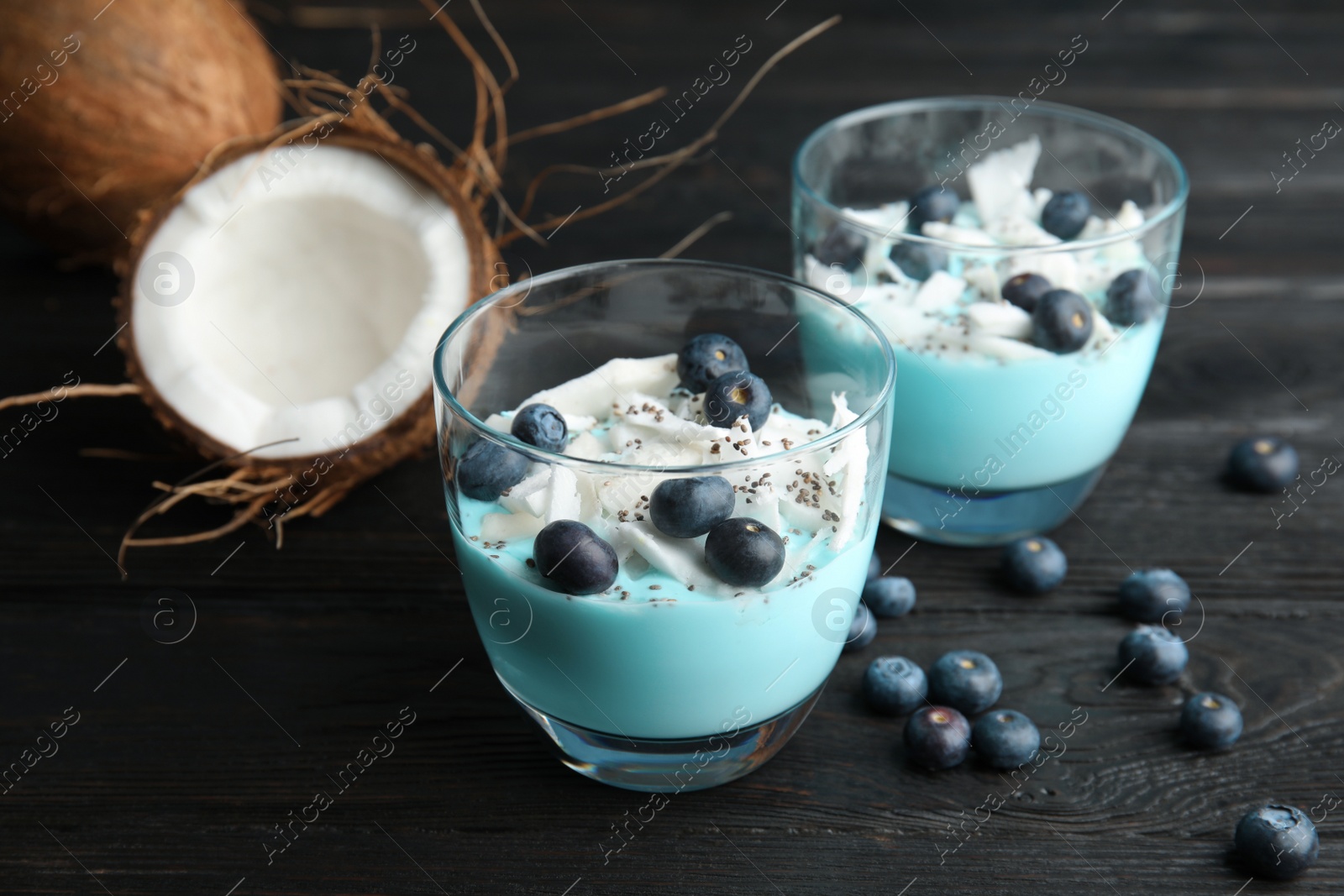 Photo of Composition with glass cups of spirulina smoothie on wooden table