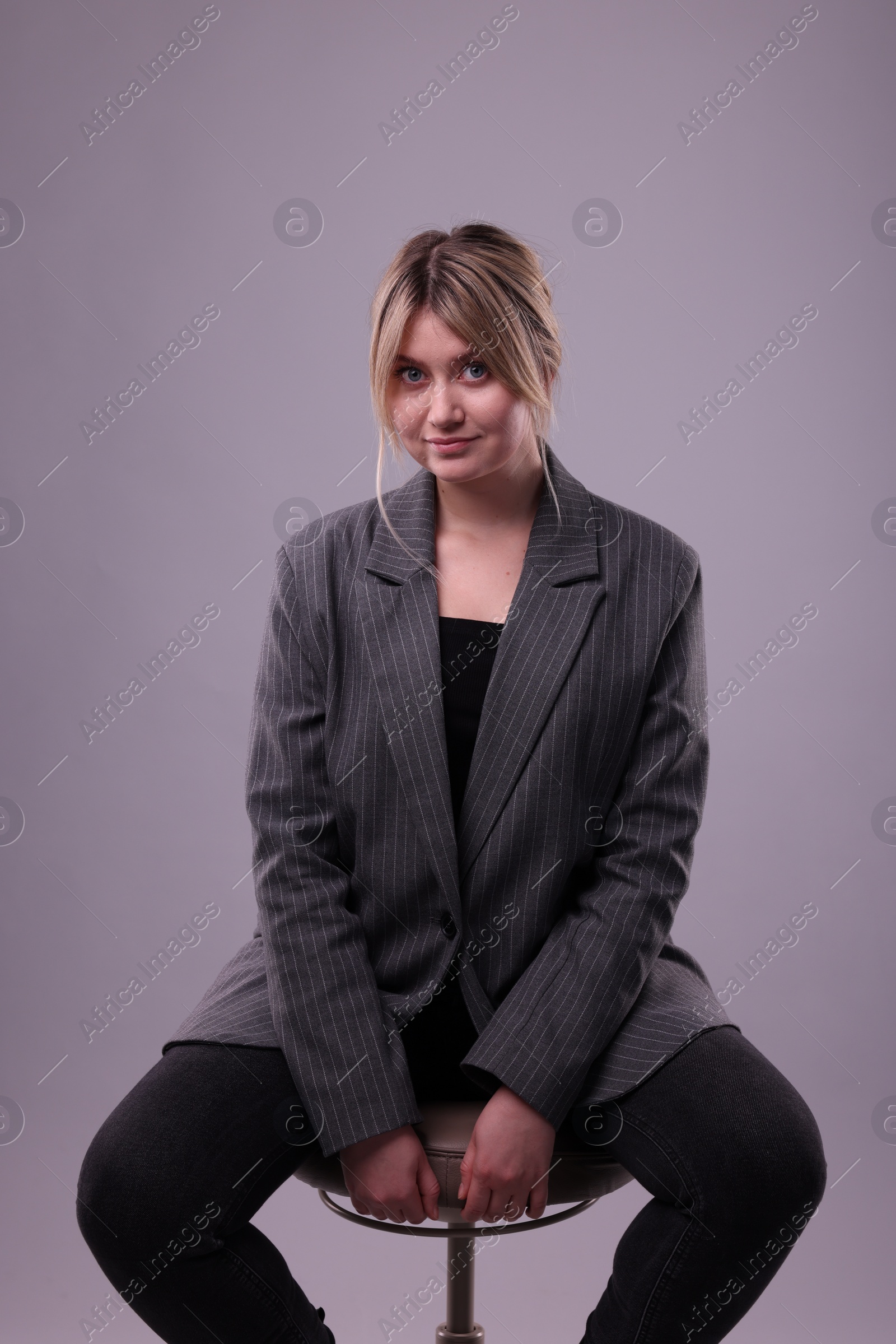 Photo of Portrait of beautiful young woman on grey background