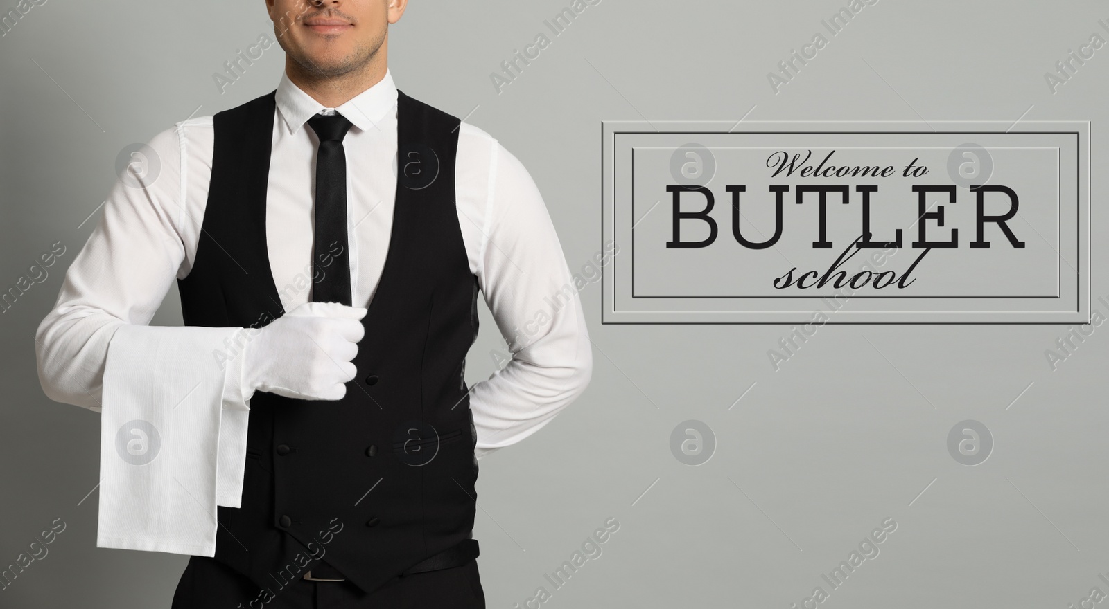 Image of Man with towel and sign Welcome To Butler School on light background