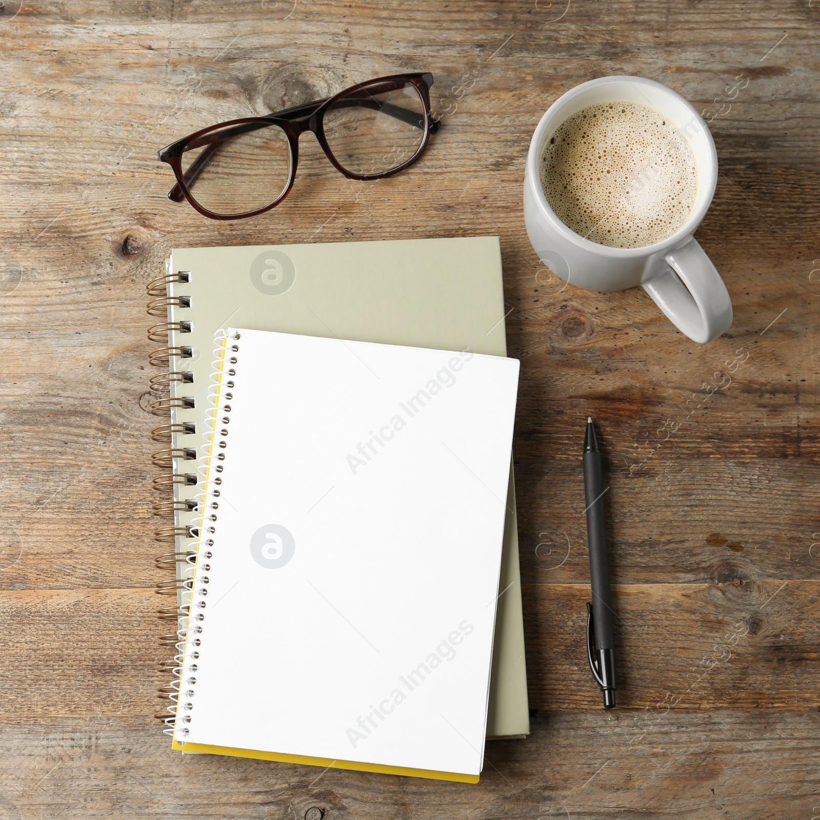 Photo of Flat lay composition with office stationery and cup of coffee on wooden table. Space for design