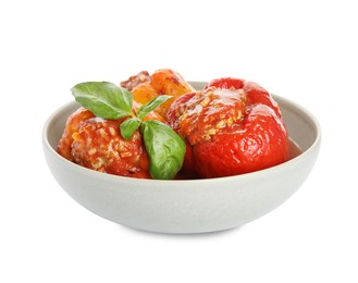 Photo of Delicious stuffed peppers with basil in bowl isolated on white