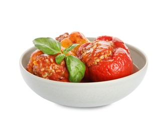 Delicious stuffed peppers with basil in bowl isolated on white