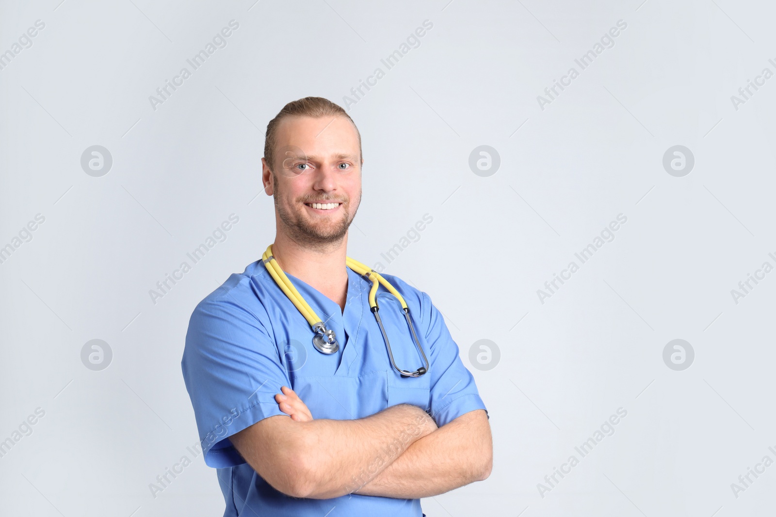 Photo of Portrait of medical assistant with stethoscope on color background. Space for text