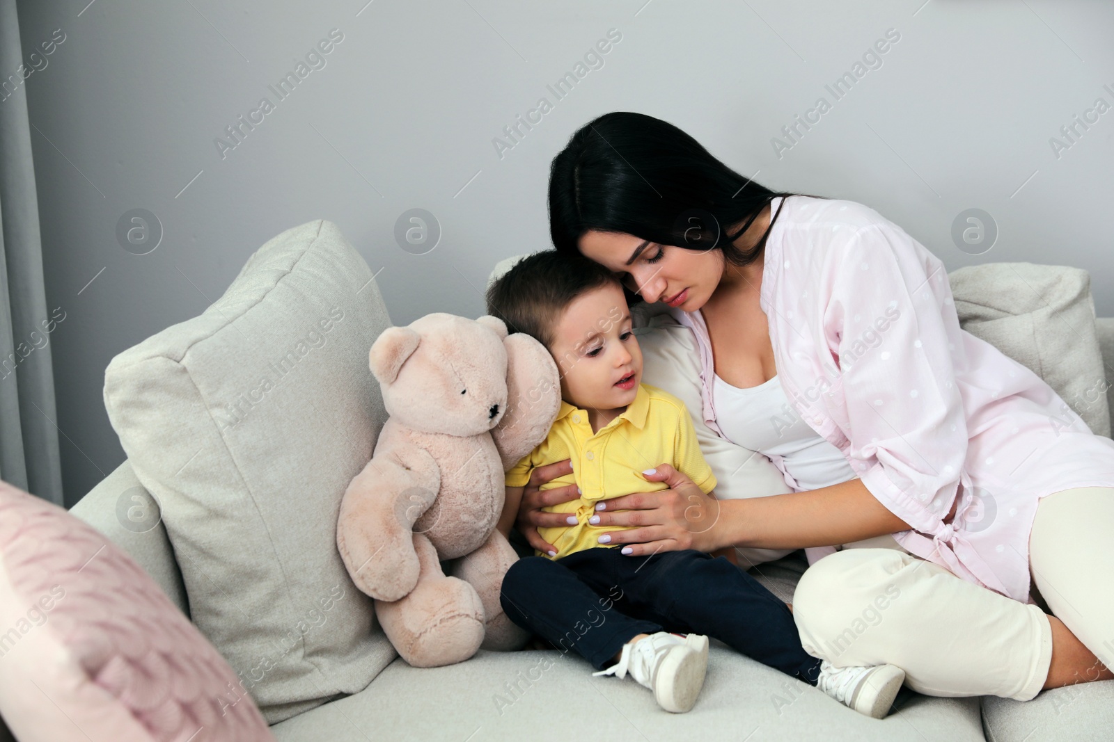 Photo of Depressed single mother with child in living room