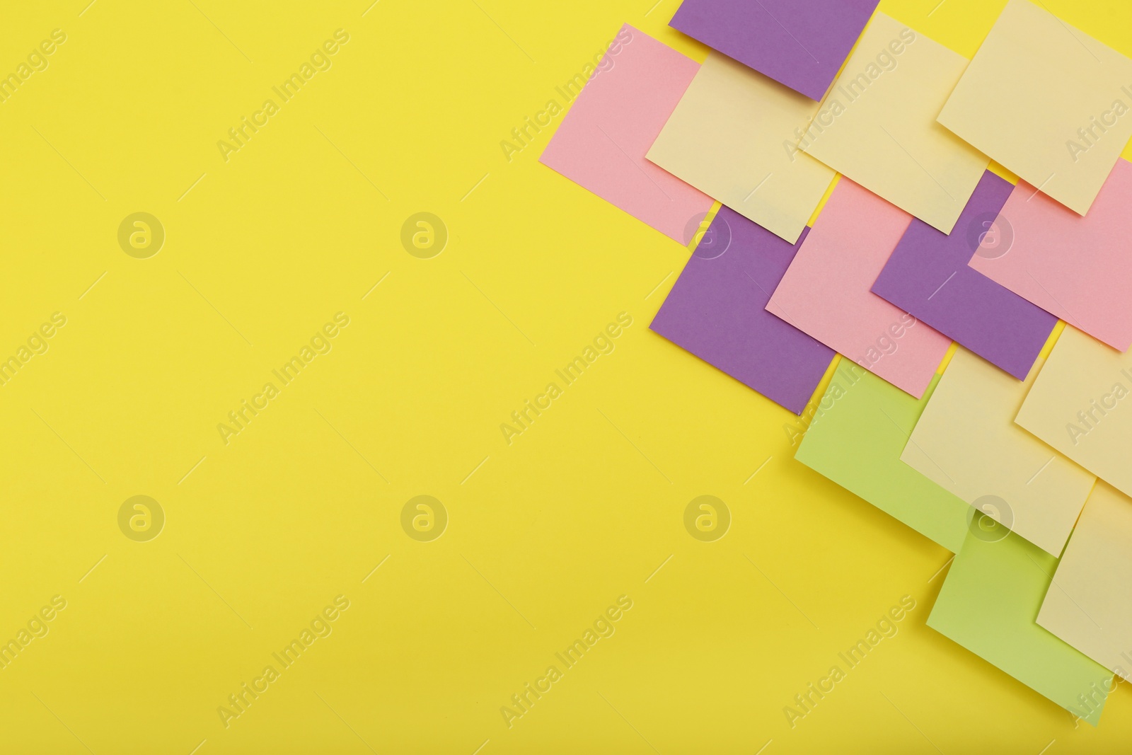 Photo of Colorful sticky notes on yellow background, flat lay. Space for text