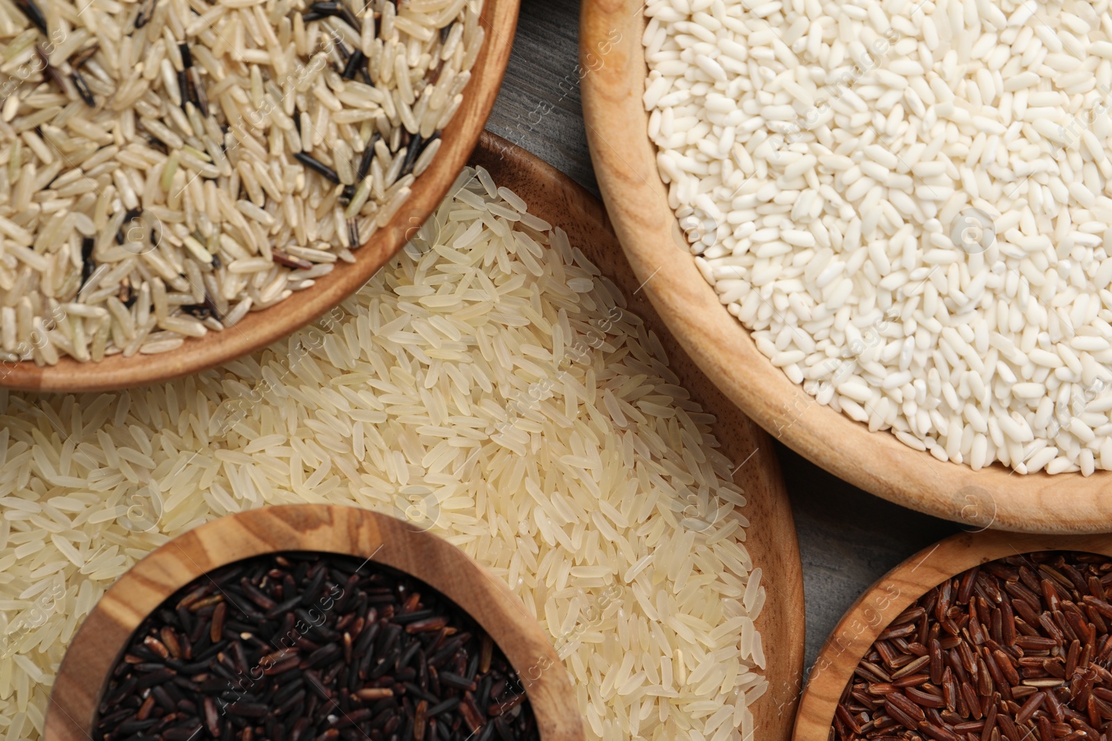 Photo of Dishes with different sorts of rice on table, flat lay