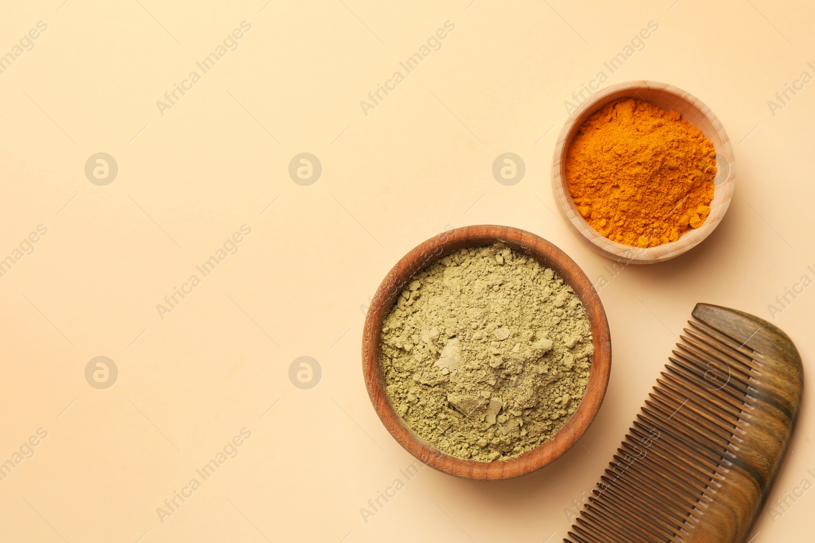 Photo of Flat lay composition with henna and turmeric powder on beige background, space for text. Natural hair coloring