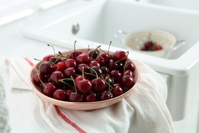Fresh ripe cherries on countertop in kitchen