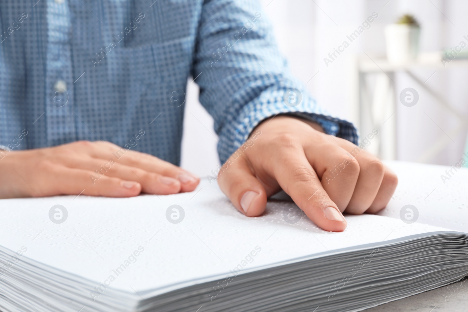 Photo of Blind person reading book written in Braille, closeup