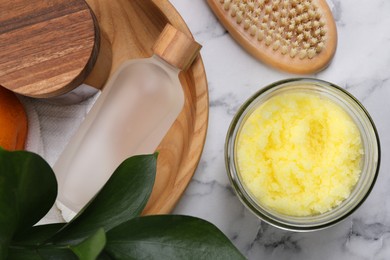 Flat lay composition with natural body scrub on white marble table. Anti cellulite treatment