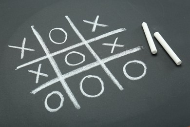 Tic tac toe game drawn on chalkboard