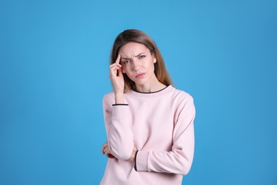 Photo of Portrait of stressed young woman on light blue background