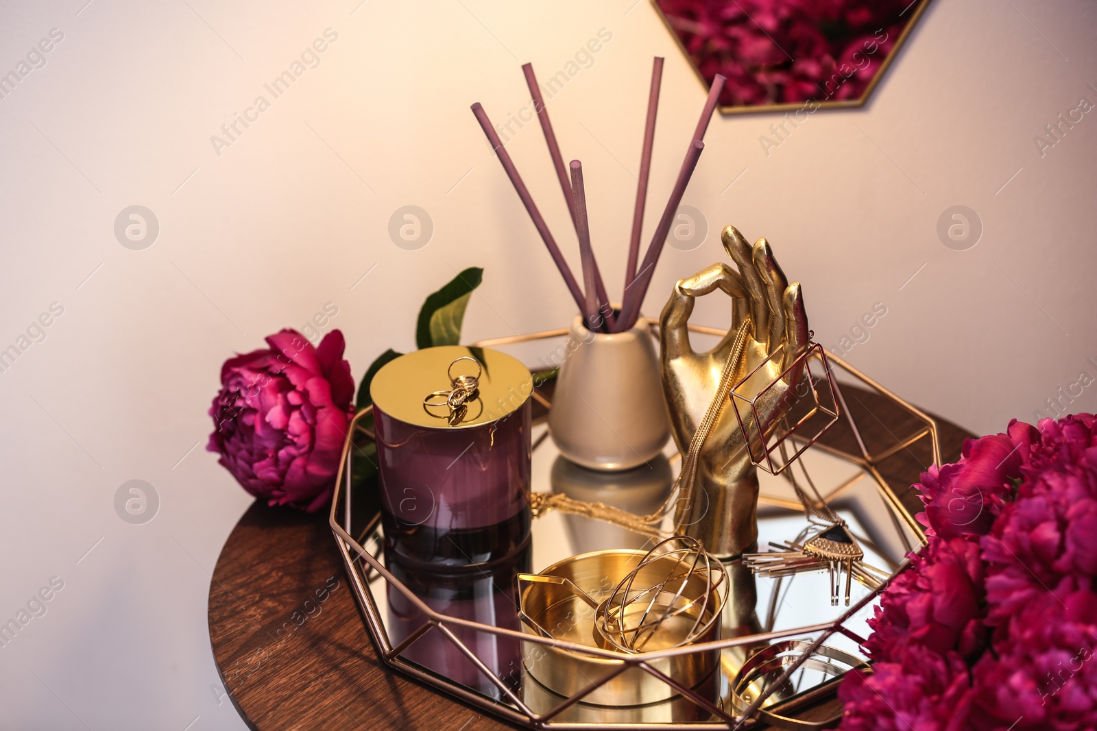 Photo of Composition with stylish accessories, flowers and interior elements on table indoors