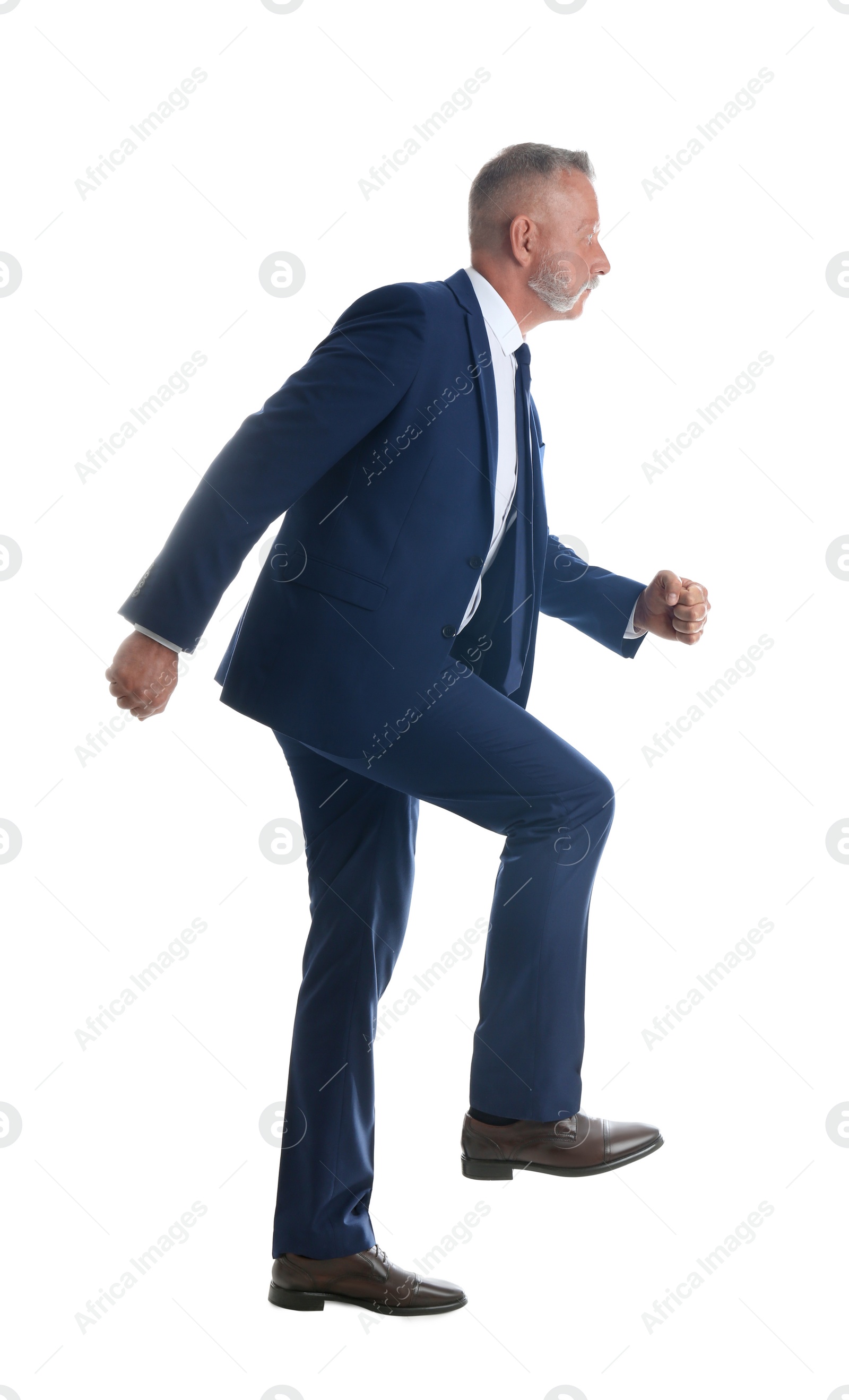 Photo of Businessman imitating stepping up on stairs against white background. Career ladder concept