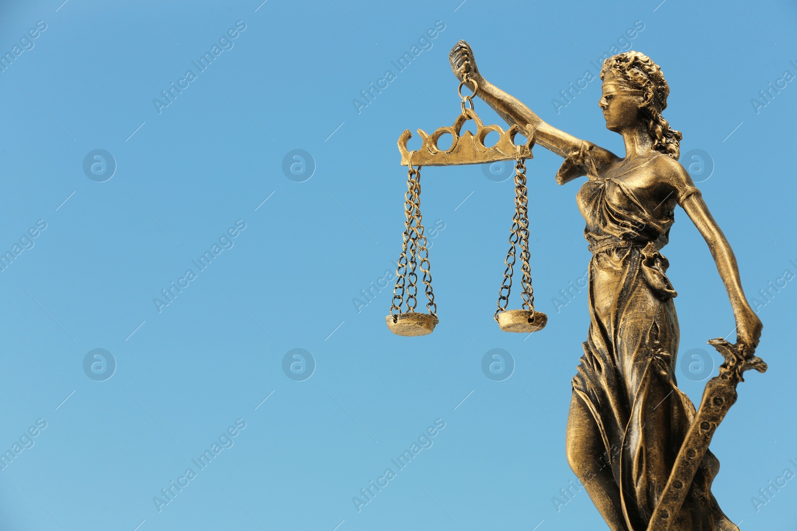 Photo of Figure of Lady Justice against sky, space for text. Symbol of fair treatment under law