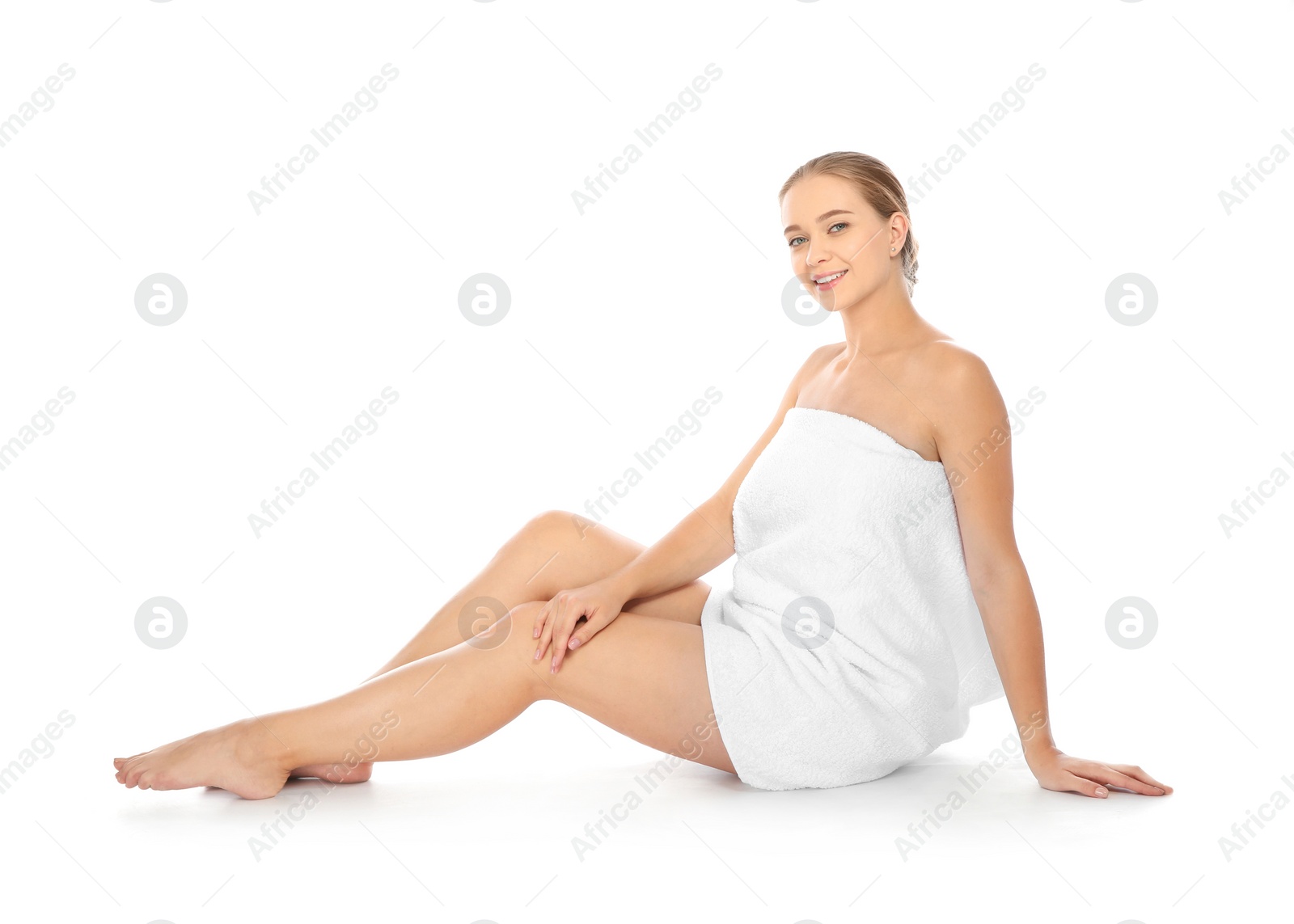 Photo of Portrait of young pretty woman with towel sitting on white background