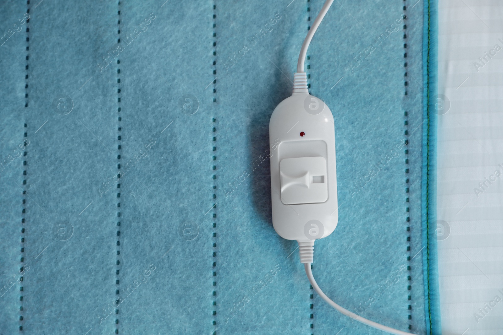 Photo of Bed with electric heating pad, top view