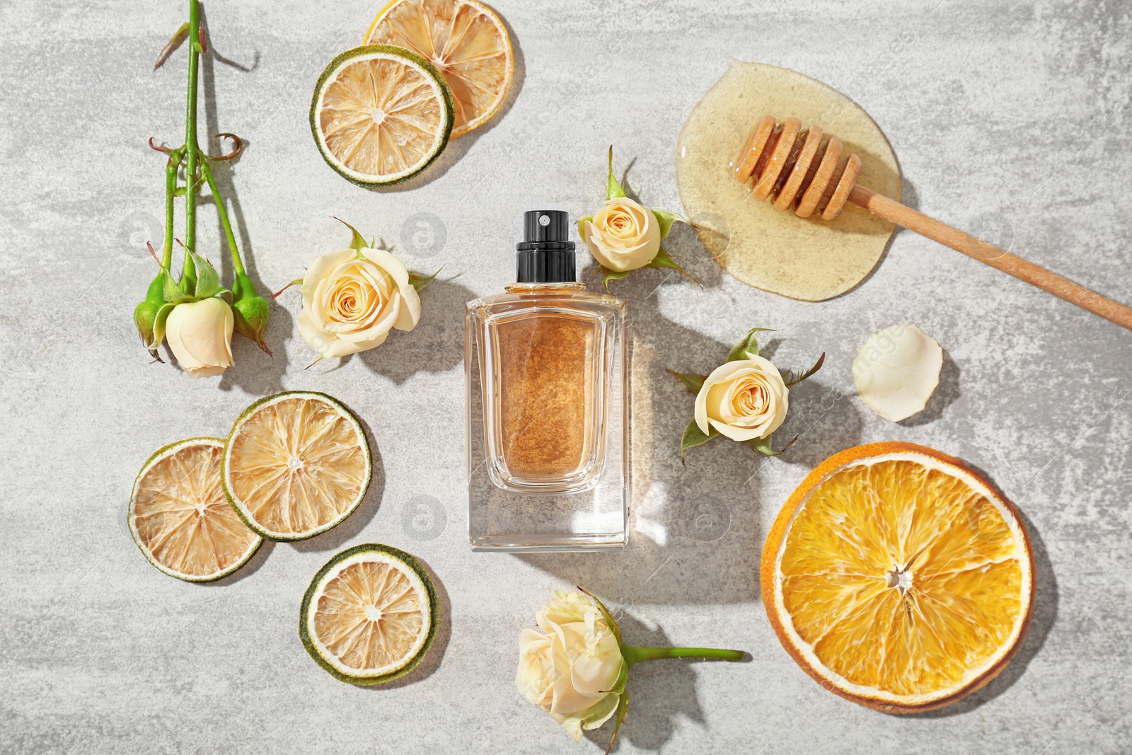 Photo of Beautiful composition with bottle of perfume on light background, flat lay