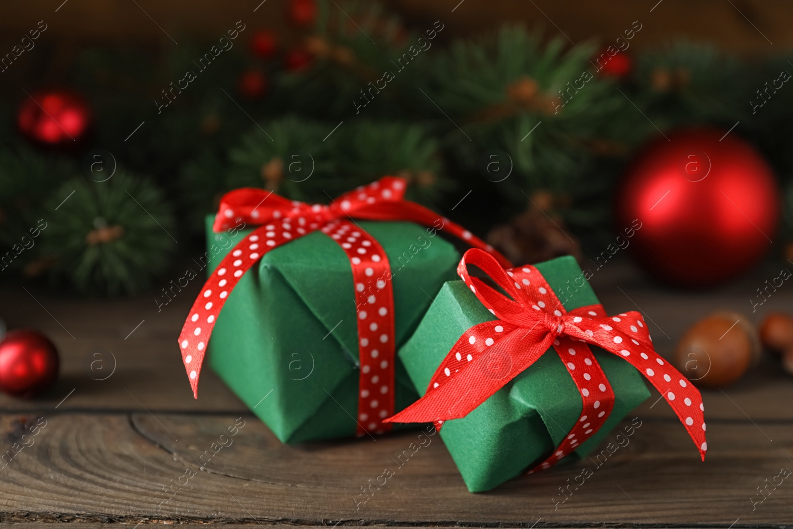 Photo of Green Christmas gift boxes with red bows on wooden table