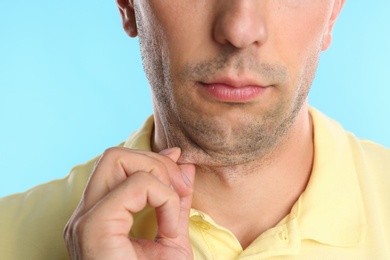 Photo of Young man with double chin on blue background, closeup