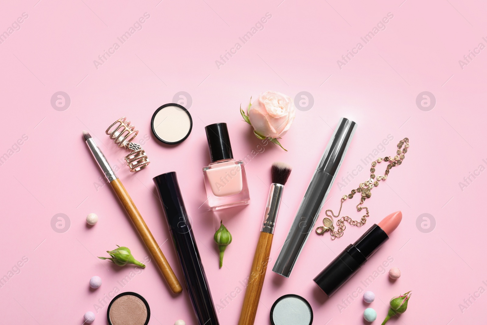 Photo of Flat lay composition with products for decorative makeup on pastel pink background