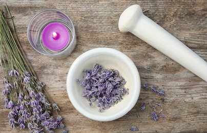 Photo of Mortar with lavender flowers on table, top view. Ingredient for natural cosmetic