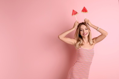 Photo of Pretty young woman with juicy watermelon on color background