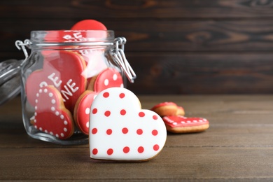 Photo of Delicious heart shaped cookies on wooden table, space for text. Valentine's Day