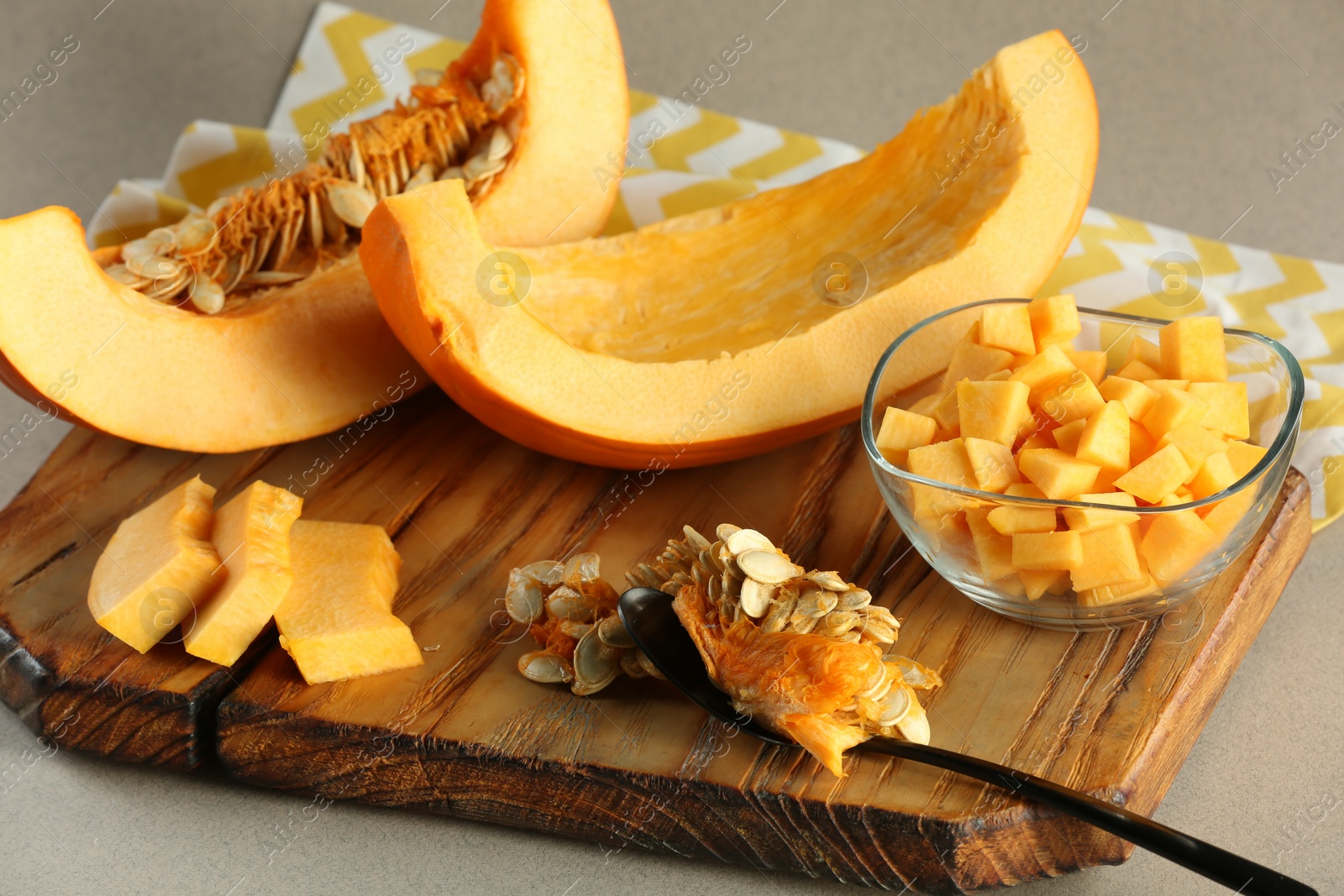 Photo of Cut fresh ripe pumpkin on grey background, closeup