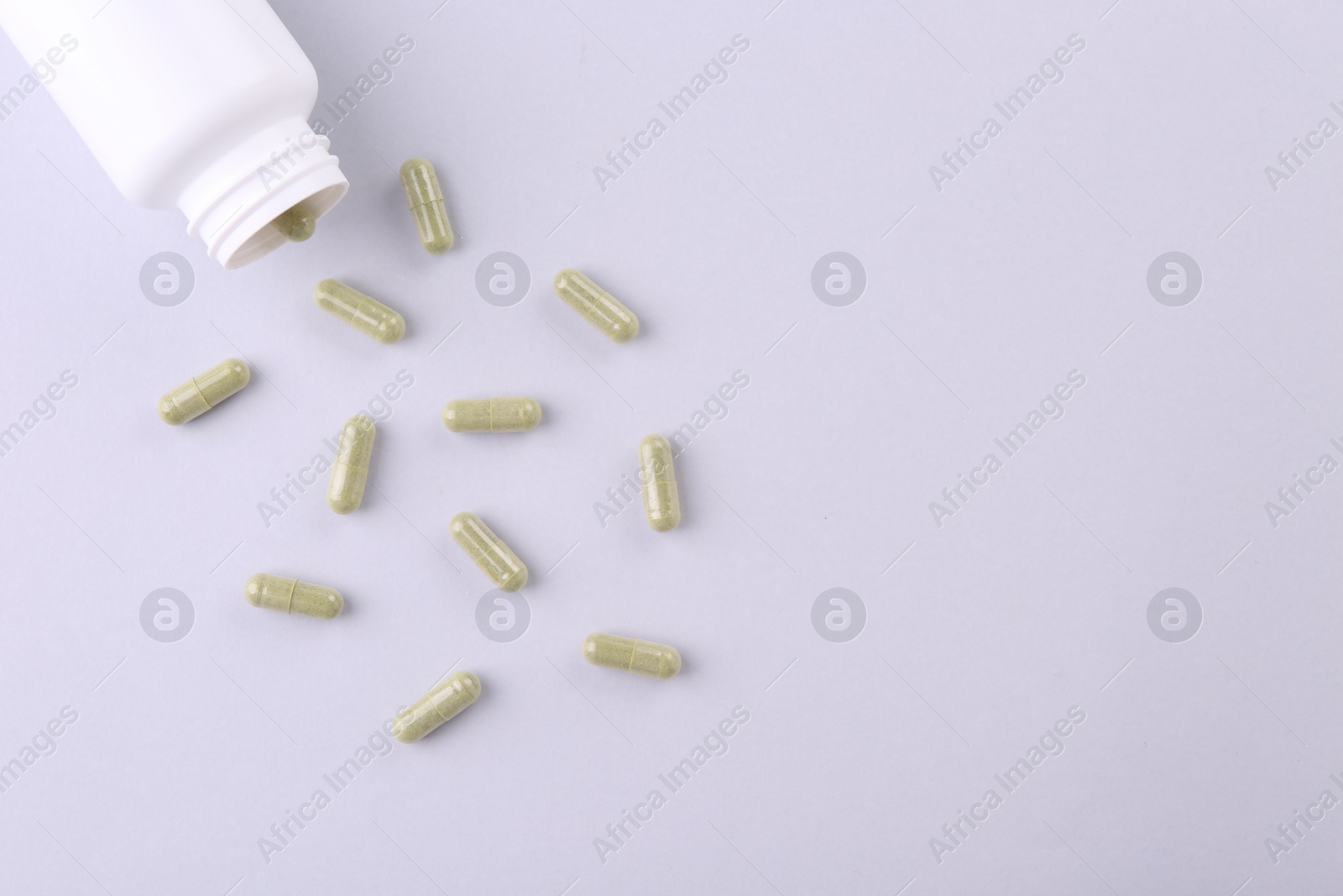 Photo of Jar with vitamin capsules on white background, flat lay. Space for text