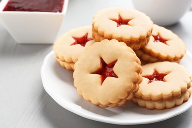 Photo of Traditional Christmas Linzer cookies with sweet jam on plate