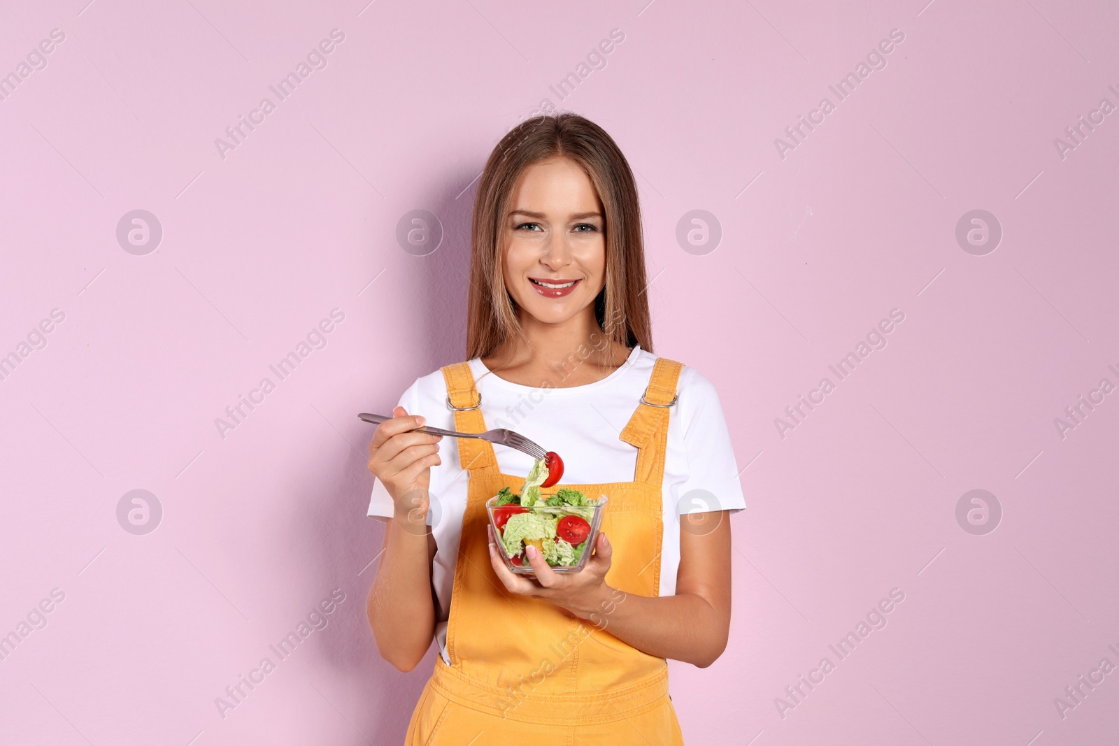 Photo of Slim woman with salad on color background. Healthy diet