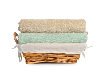 Photo of Wicker basket with folded bath towels isolated on white
