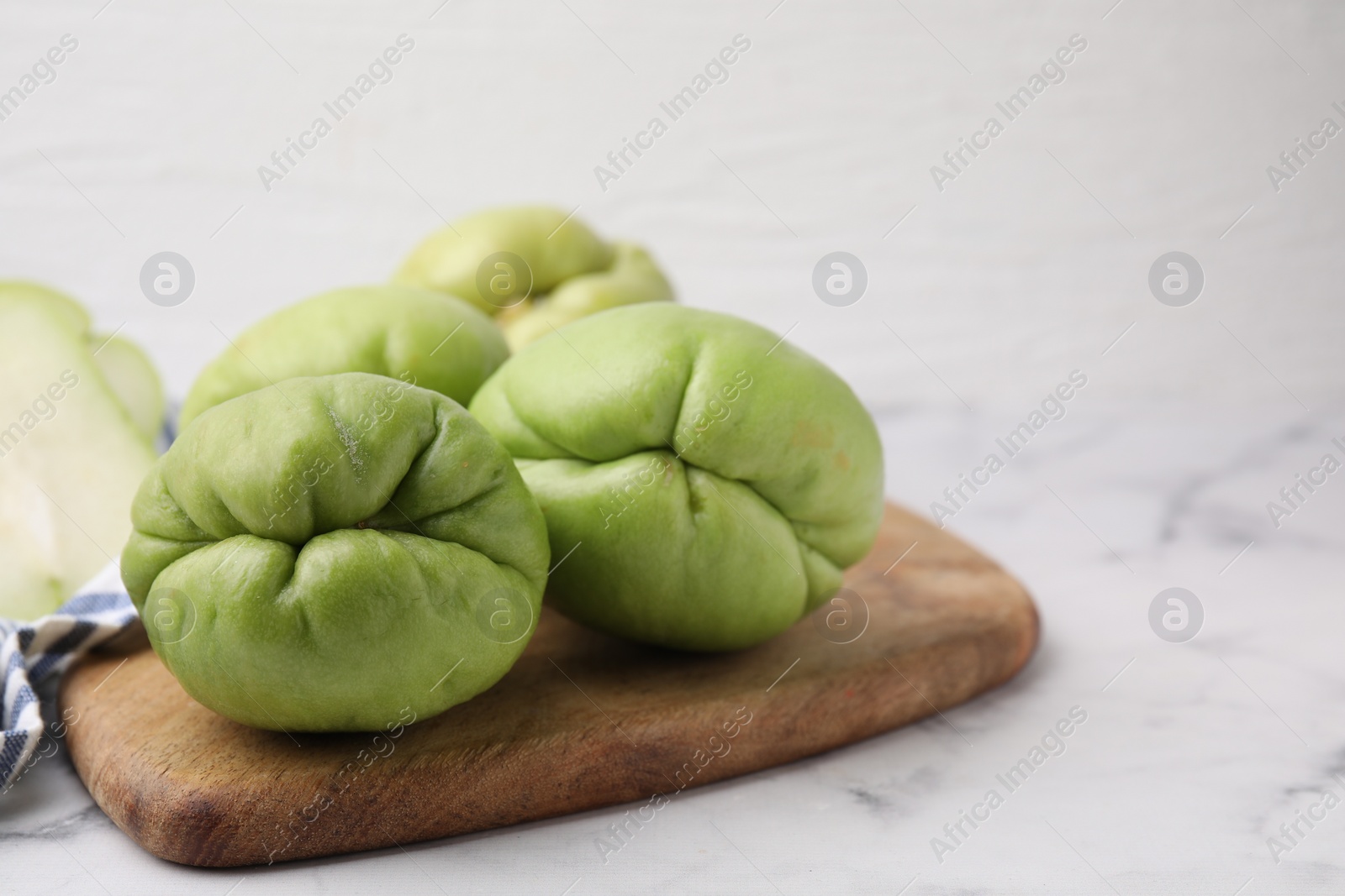 Photo of Fresh green chayote on light table, closeup