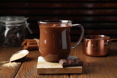 Cup of delicious hot chocolate on wooden table