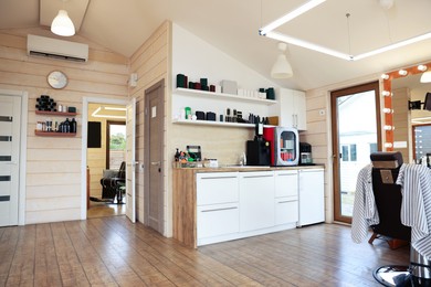 Photo of Stylish barbershop interior with professional hairdresser's workplace